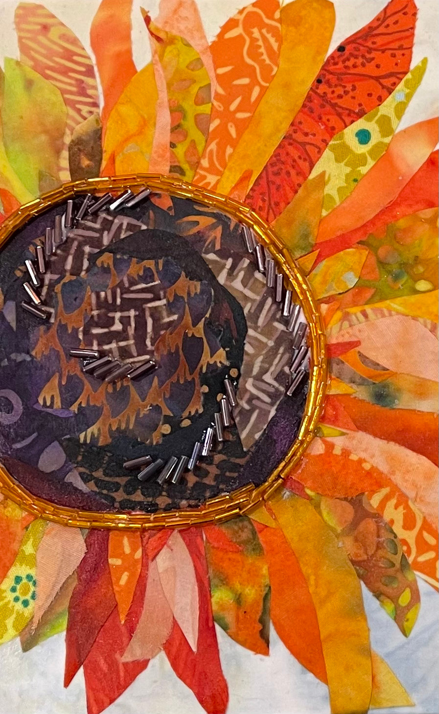 Sunflower wall art in fabric mixed media with layered petals, warm tones, and dimensional textile detail