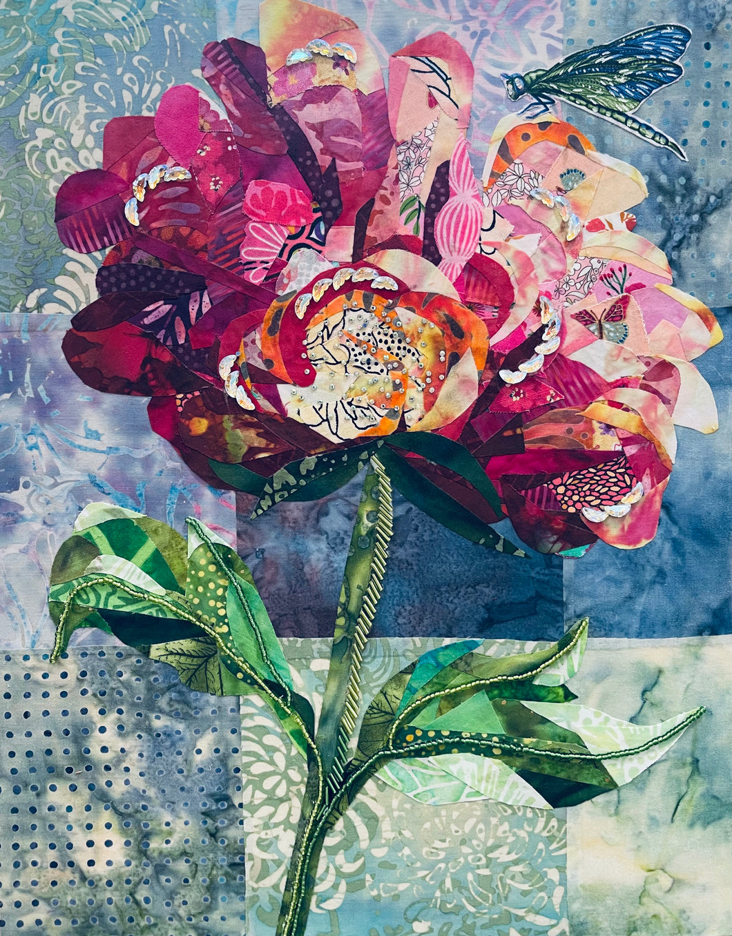 Floral wall art in fabric mixed media with layered petals, botanical design, and dimensional textile detail with dragonfly accent