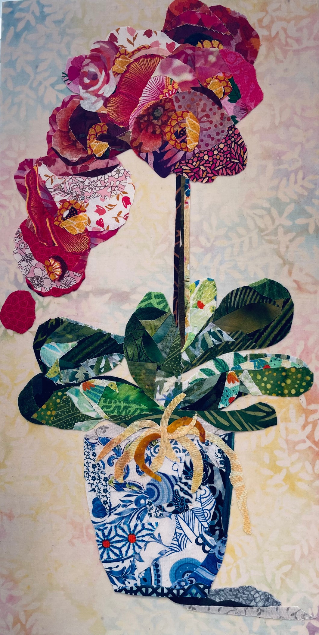 Floral still life wall art in fabric mixed media with layered flowers in a blue and white Chinoiserie style vase