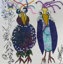Whimsical textile bird art showing two quirky birds with colorful beaded accents and expressive features on a neutral background