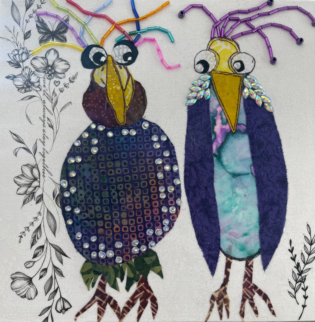 Whimsical textile bird art showing two quirky birds with colorful beaded accents and expressive features on a neutral background