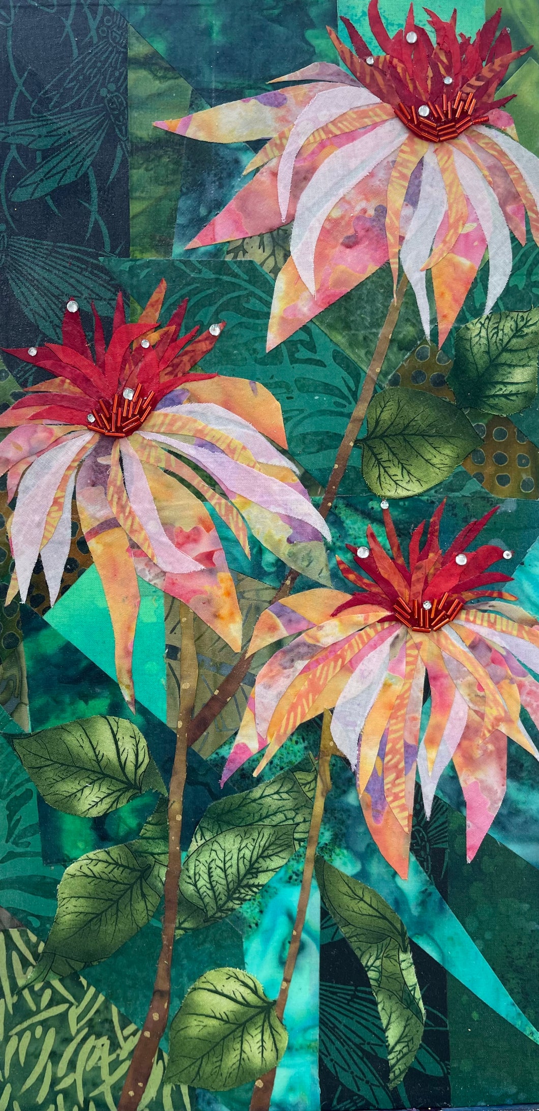 Floral fabric mixed media wall art with vibrant layered flowers, green botanical background, and beaded centers