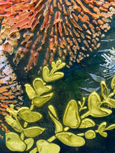 Close-up of textured surface with yellow leaf-like shapes and multicolored abstract patterns.