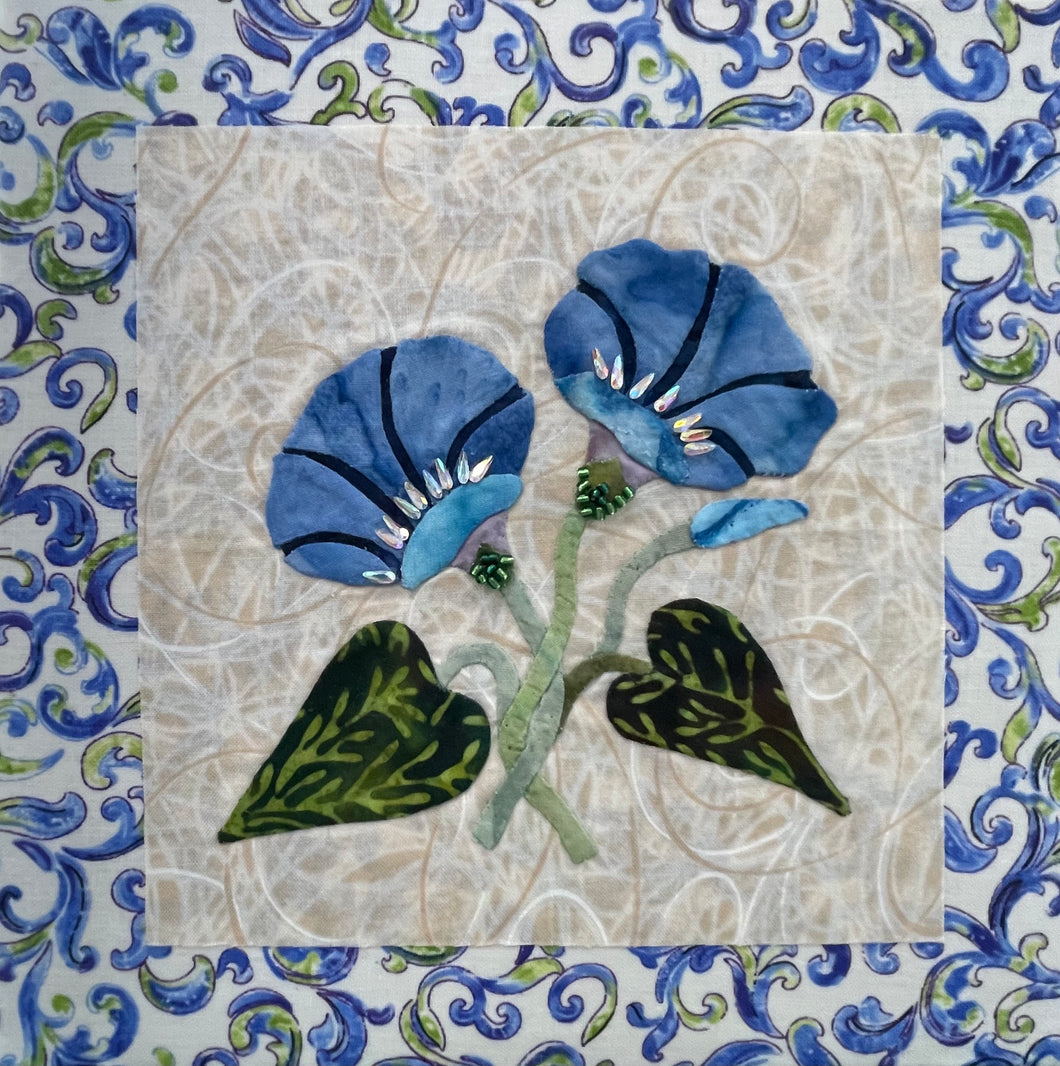 Artistic depiction of blue flowers with green leaves on a textured beige background, surrounded by decorative blue floral patterns.