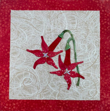 Two red fabric collage flowers with crystal centers and green stems on a neutral textile background, mounted on an 8x8 panel