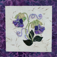 Fabric design of purple flowers on a textured white fabric with a purple patterned background.