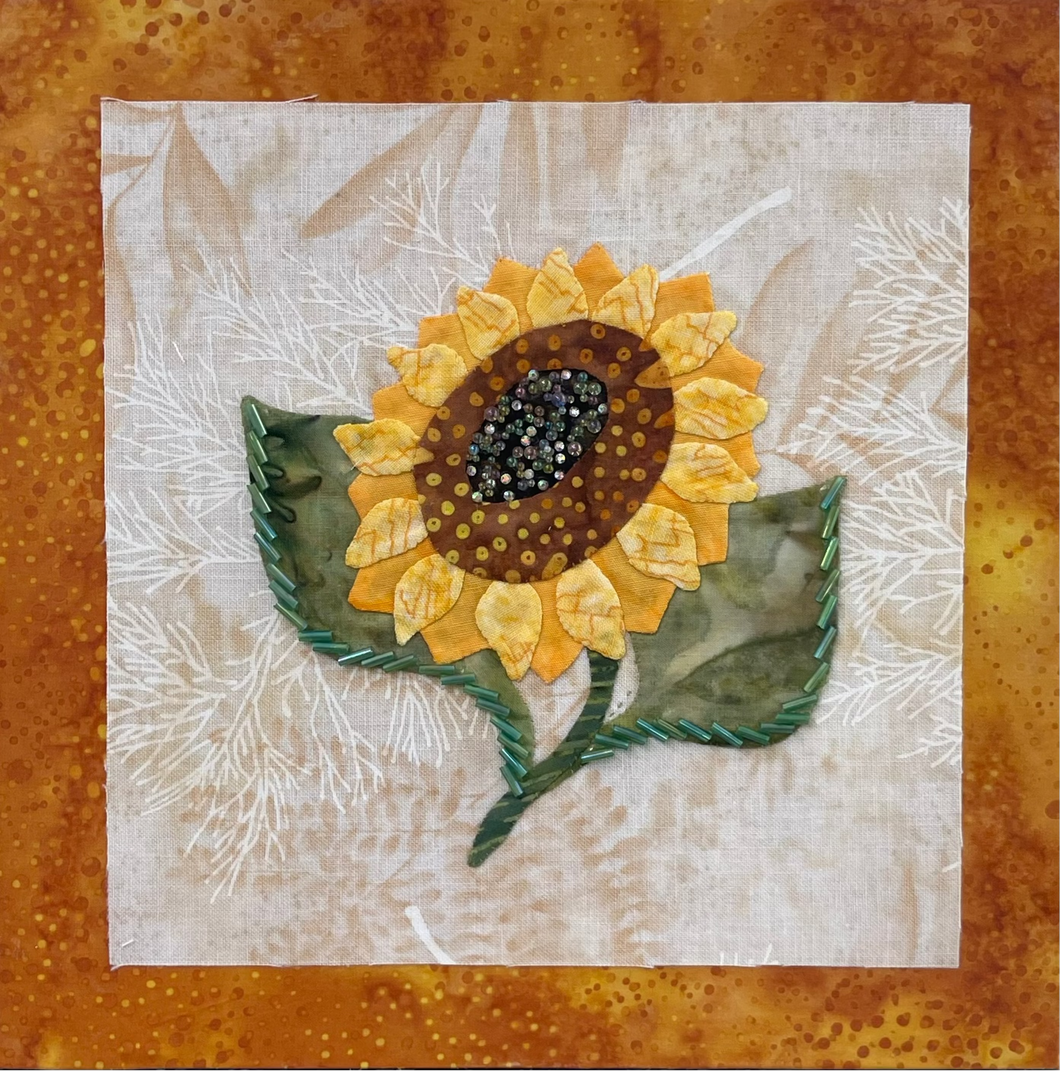 Sunflower art piece on fabric with a orange border