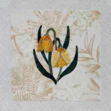Yellow and gold bell-shaped fabric flowers with beadwork and crystal detail on a soft neutral textile background, mounted on an 8x8 panel