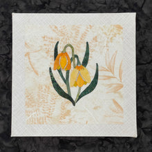 Layered fabric floral design on a textured black background