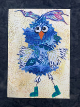 Quirky blue owl fabric collage artwork with patterned wings and expressive eyes wearing polka dot boots