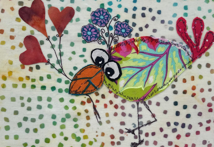 Whimsical fabric collage bird holding heart-shaped balloons on a colorful dotted background with playful stitched looking details 