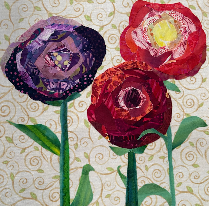 Fabric flower artwork with three layered blooms in red, coral, and purple tones on 8x8 panel with patterned background