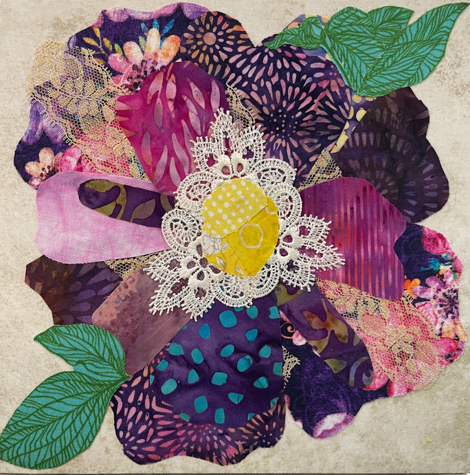 Fabric flower artwork with layered purple and pink textiles and lace center on 8x8 panel with green leaves