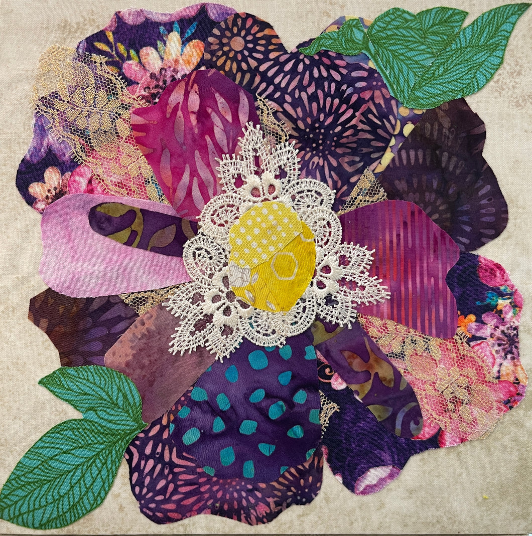Fabric flower artwork with layered purple and pink textiles and lace center on 8x8 panel with green leaves