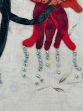 Close-up of red fabric flower with cystals dripping down