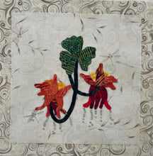 8 x 8 fabric collage artwork featuring red and orange flowers with cascading bead details and green leaves made from inherited textiles