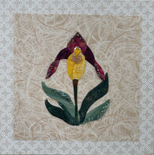 8 x 8 fabric collage artwork featuring a single yellow and burgundy flower made from inherited textiles with bead embellishments on neutral background