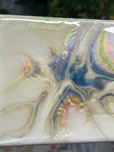 Quiet Tide resin artwork featuring luminous pearl, gold, blue, and soft green color-shifting pigments flowing across a glossy abstract surface in a floating frame.