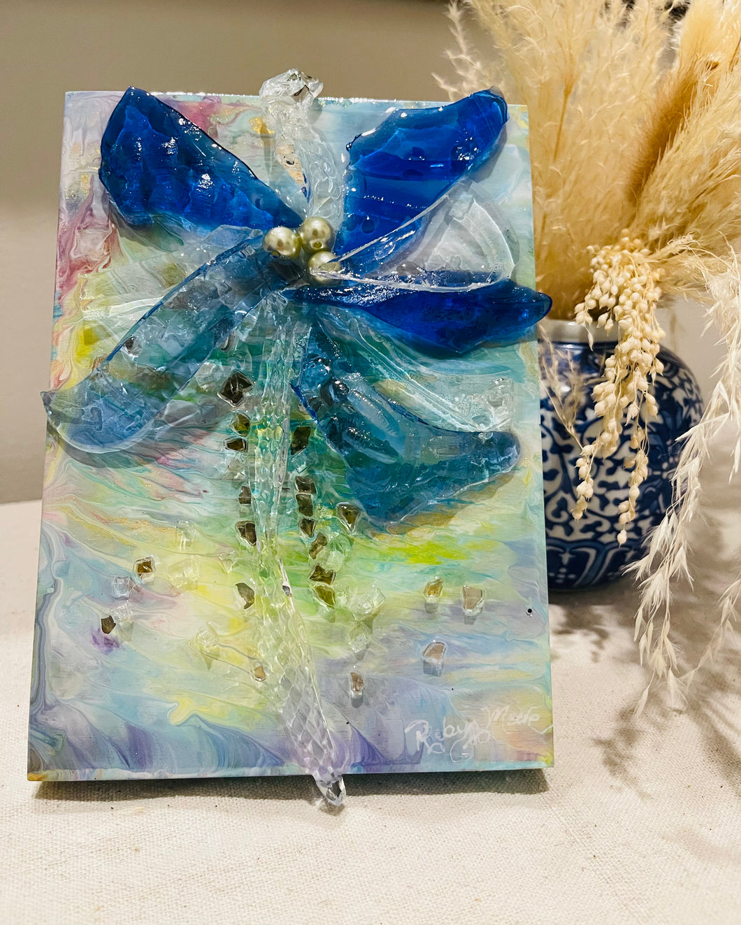 Palm tree artwork made with recycled glass and resin, featuring soft coastal colors and reflective texture