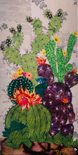 Original flowering cactus fabric artwork 6x12 inches, tall columnar green cacti dramatic dark spotted cactus with vivid pink orange blooms purple prickly pear Swarovski crystals ink pen spine detail, vintage toile botanical text background warm brown ground, birch panel, Floral Botanical Collection, Robyn Moore Arts
