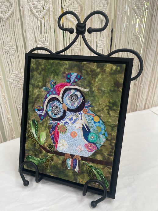 Original whimsical owl fabric artwork 8x10 inches, patchwork owl in blue lavender teal magenta coral fabric with Czech glass bead eye rings spiral center eyes Swarovski crystal flower details purple fabric crown Czech glass bead leaf branch, deep olive brown batik background, birch panel, Whimsical Companions Collection, Robyn Moore Arts