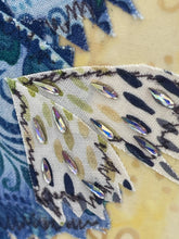 Close detail of Swarovski crystal accents on the painted feather wingtips and lower wing edge of A Little Offbeat by Robyn Moore Arts