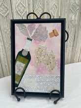 Original champagne fabric artwork 8x12 inches, champagne bottle in green olive fabric with vintage script label two gold polka dot flutes toasting Swarovski crystal bubbles fabric champagne spray cork detail, soft pink batik bokeh background white floral dimensional ground, birch panel, Whimsical Companions Collection, Robyn Moore Arts