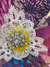 Close detail of the Swarovski crystal cluster and lace medallion center on Where Layers Gather by Robyn Moore Arts, layered batik fabric petals