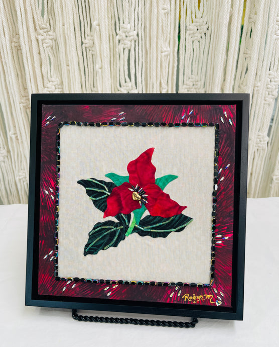 8 x 8 fabric collage artwork featuring a deep red flower with a gold heart center and green beaded leaves made from inherited textiles