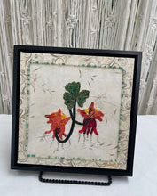 8 x 8 fabric collage artwork featuring red and orange flowers with cascading bead details and green leaves made from inherited textiles