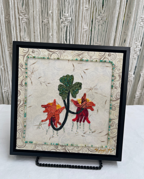 8 x 8 fabric collage artwork featuring red and orange flowers with cascading bead details and green leaves made from inherited textiles