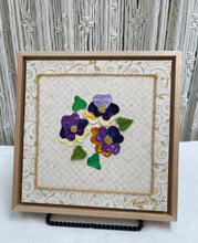 8 x 8 fabric collage artwork featuring a cluster of purple and cream flowers with beaded centers made from inherited textiles