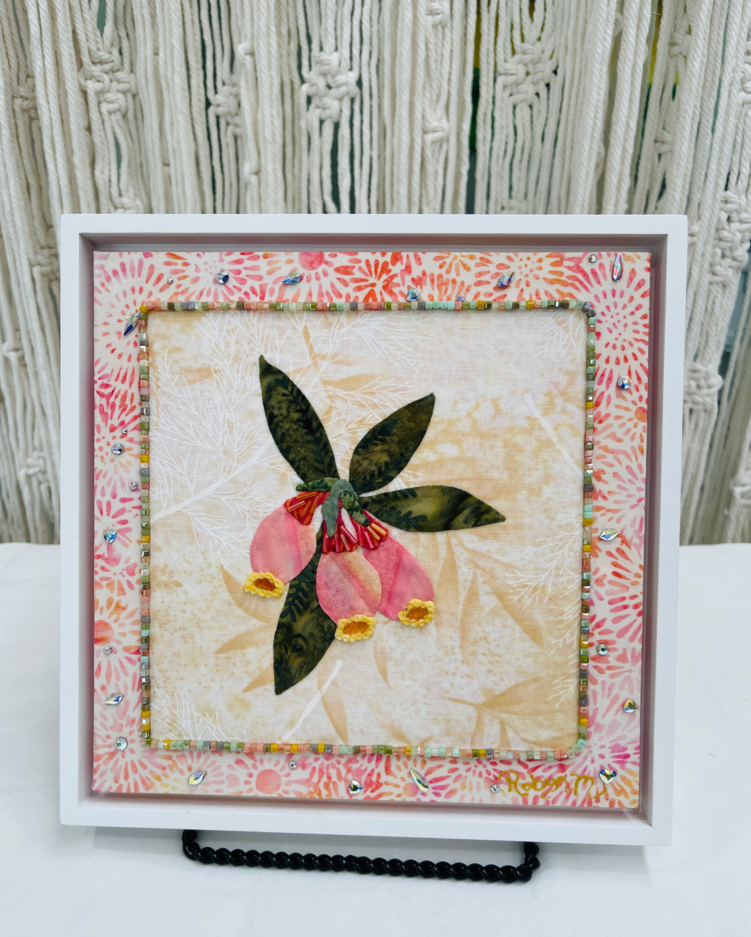 8 x 8 fabric collage artwork featuring soft blush flowers with gold accents and green leaves made from inherited textiles
