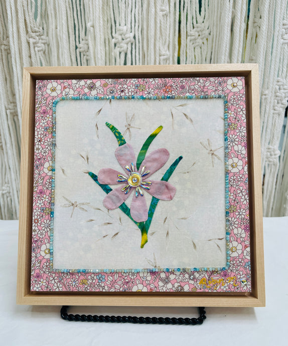 Original pink flower fabric artwork 8x8 inches, single pink bloom with green leaves, Czech glass bead border, Swarovski crystals in the center and floral fabric border, light maple floating frame, Inherited Blooms Collection, Robyn Moore Arts