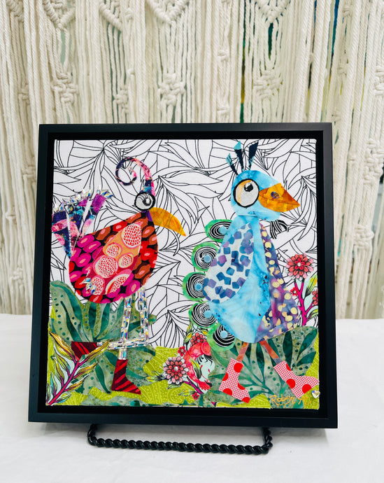 Original whimsical bird fabric collage artwork 8x8 inches, two quirky birds in magenta crimson and sky blue patterned batik fabric, crystal embellished legs and feathers, Czech glass bead tail detail, botanical line drawing fabric background, birch panel, Whimsical Companions Collection, Robyn Moore Arts