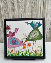 Whimsical textile bird art showing two colorful birds facing each other with flowers and butterflies in a playful garden scene