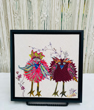 Whimsical bird textile art with two colorful patterned birds standing together on a soft neutral background