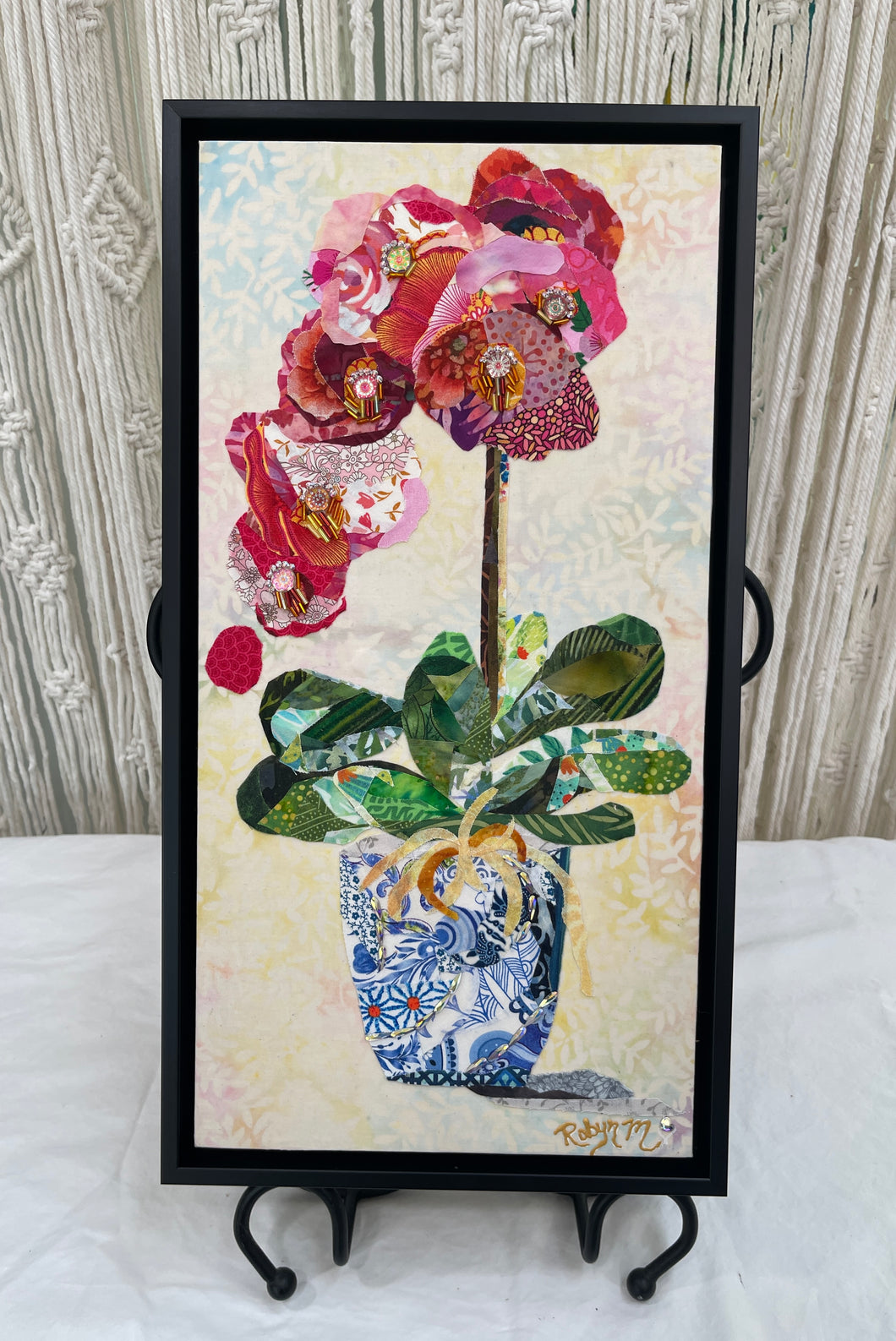 Original orchid fabric artwork 8x16 inches, cascading orchid blooms in magenta crimson blush pink batik fabric, Czech glass beads, Swarovski crystals, chinoiserie blue white fabric pot, gold ribbon detail, soft peach background, birch panel, Floral Botanical Collection, Robyn Moore Arts