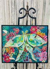Original mixed media luna moth artwork 16x20 inches, large luna moth with patchwork fabric wings in sage, celadon and cream with gold foil detail, Swarovski crystals and Czech glass beads, set against a deep teal background of painted florals in magenta, crimson and blue, on birch panel, part of the Floral and Botanical and Whimsical Companions Collections