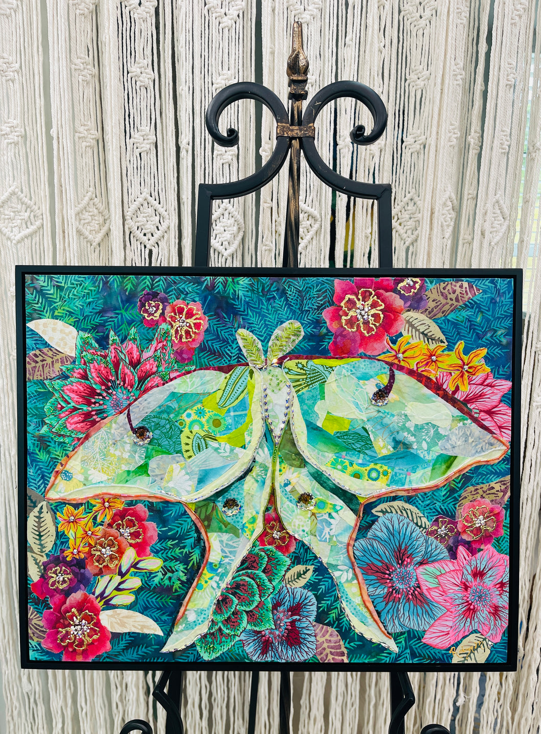 Original mixed media luna moth artwork 16x20 inches, large luna moth with patchwork fabric wings in sage, celadon and cream with gold foil detail, Swarovski crystals and Czech glass beads, set against a deep teal background of painted florals in magenta, crimson and blue, on birch panel, part of the Floral and Botanical and Whimsical Companions Collections