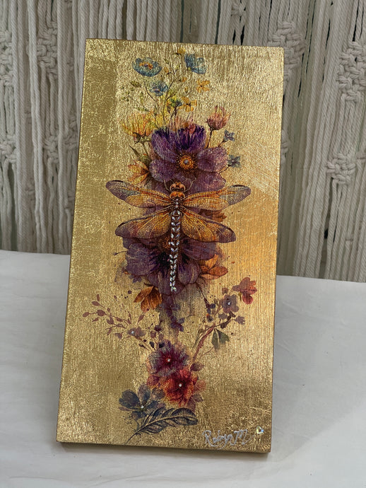 Gold leaf wood panel titled Remembrance featuring a dragonfly surrounded by plum and violet florals, hand-signed by the artist, 6x12 inches.