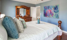 Original large format botanical acrylic painting The Air Between Colors by Robyn Moore Arts displayed in a bedroom on a wide horizontal wall in a coastal or light filled airy interior