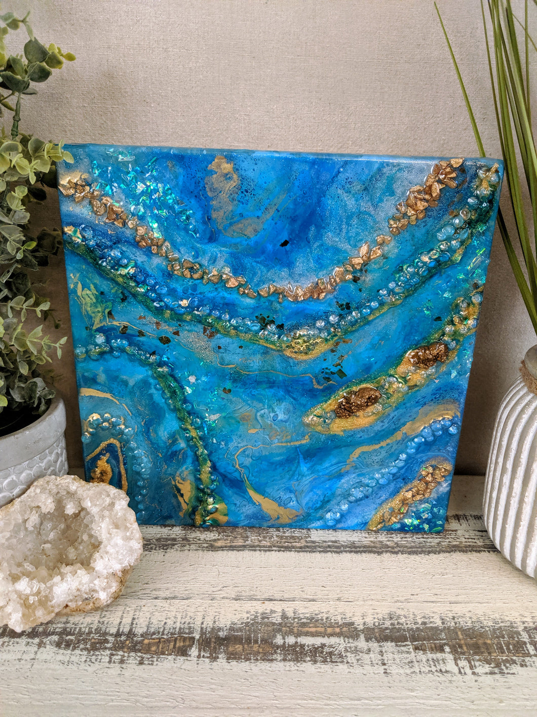 abstract fluid resin painting vibrant blue teal green gold colors with fire glass