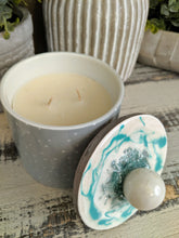 green and white polka dot candle canister with teal white sphere lid