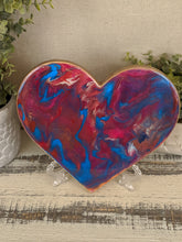 abstract fluid resin heart in shades of pink and teal with glitter
