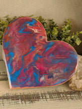 abstract fluid resin heart in shades of pink and teal with glitter