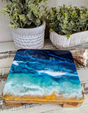 wood trivet with abstract fluid resin in ocean colors blue teal white