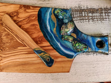 ocean color cheese board with shells with knife