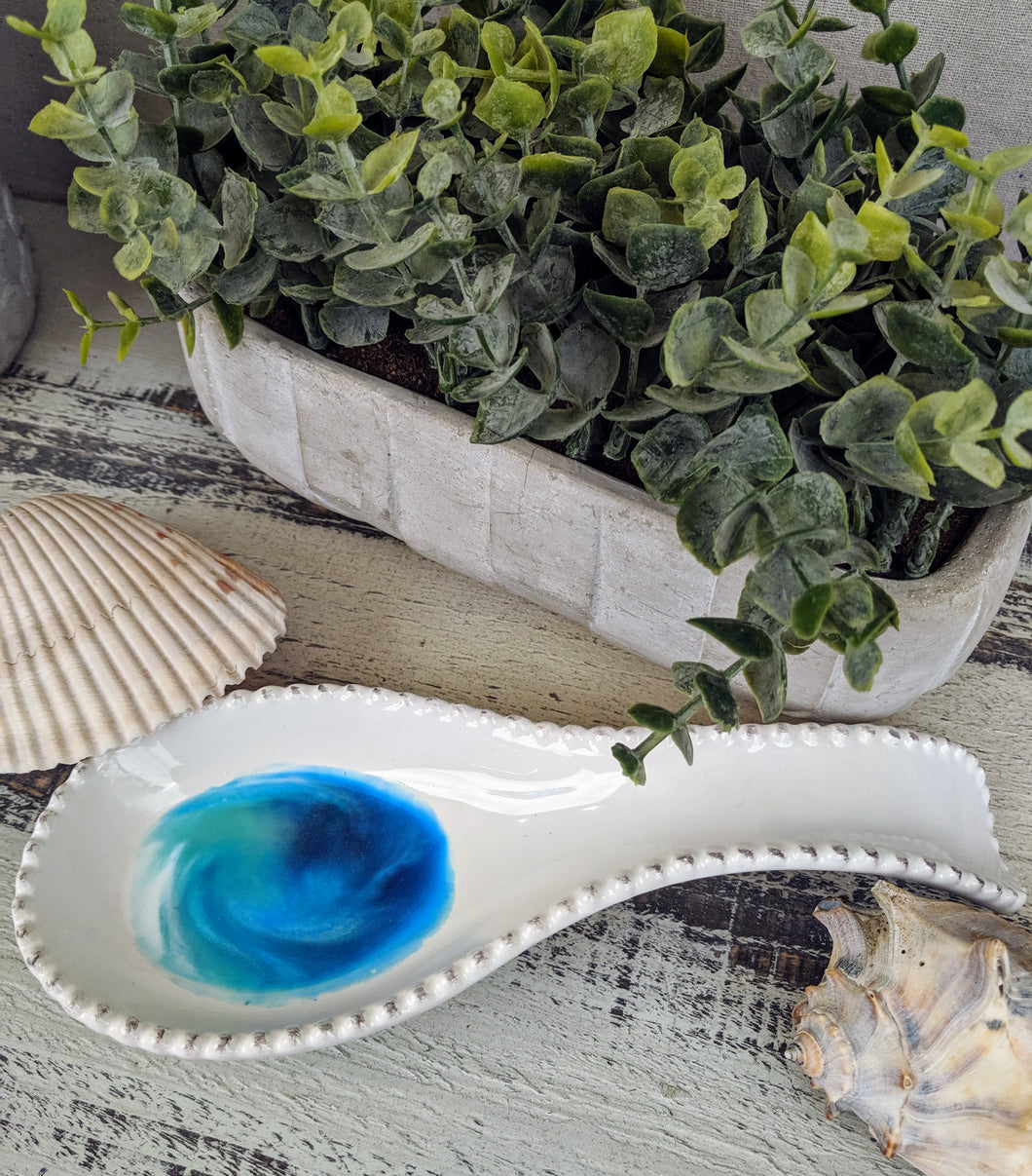 white ceramic spoon rest with ocean inspired resin