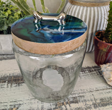 clear glass dog treat canister with wood lid coated in blue green white bronze resin with silver bone